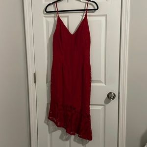 Sassy form fitting red lace dress with asymmetrical hem